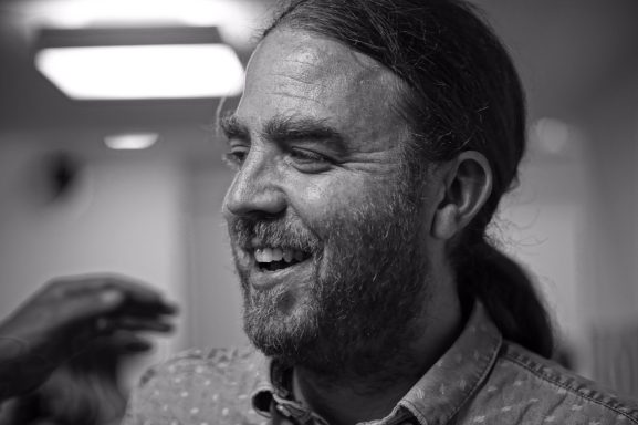 Close-up black and white photo of Gabriel McCaslin smiling.
