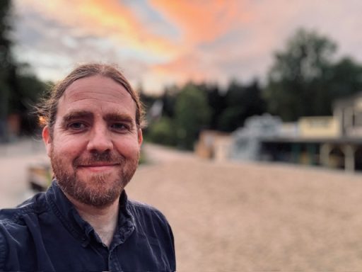 Gabriel McCaslin smiling with a sunset in the background.