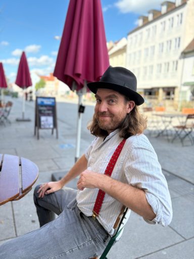 Gabriel McCaslin leaning back with his hat pushed back, smiling at the camera.