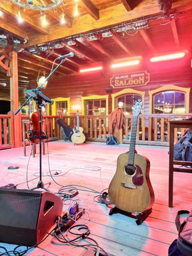 Gabriel McCaslin's guitar and microphone stand on the outdoor stage at Pullman City, Bavaria.